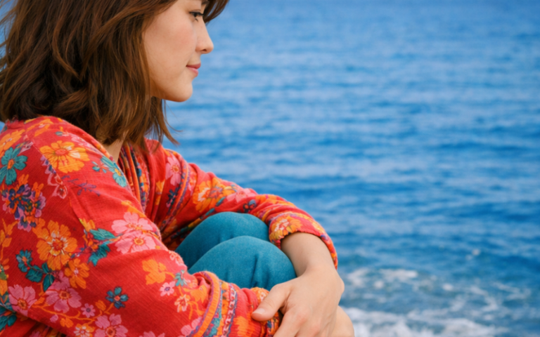 Introvert girl sitting alone near the sea.